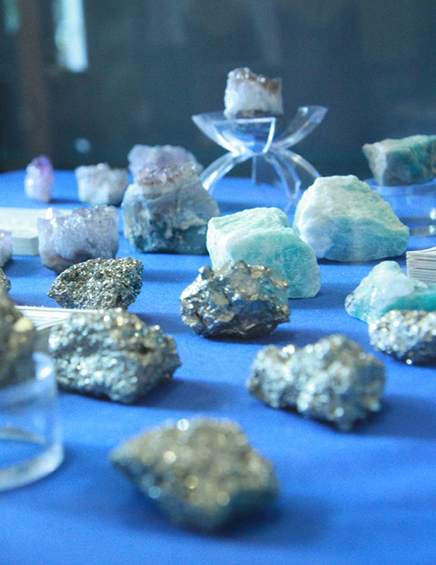 assorted gemstones arranged in a display case